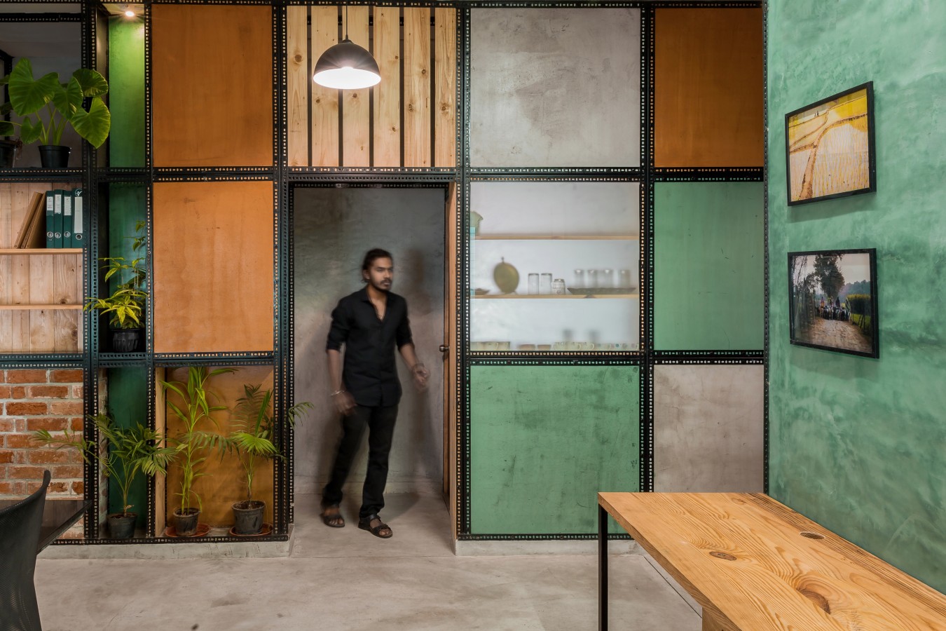 View of the partition wall composed of various plaster panels as seen from the Workspace