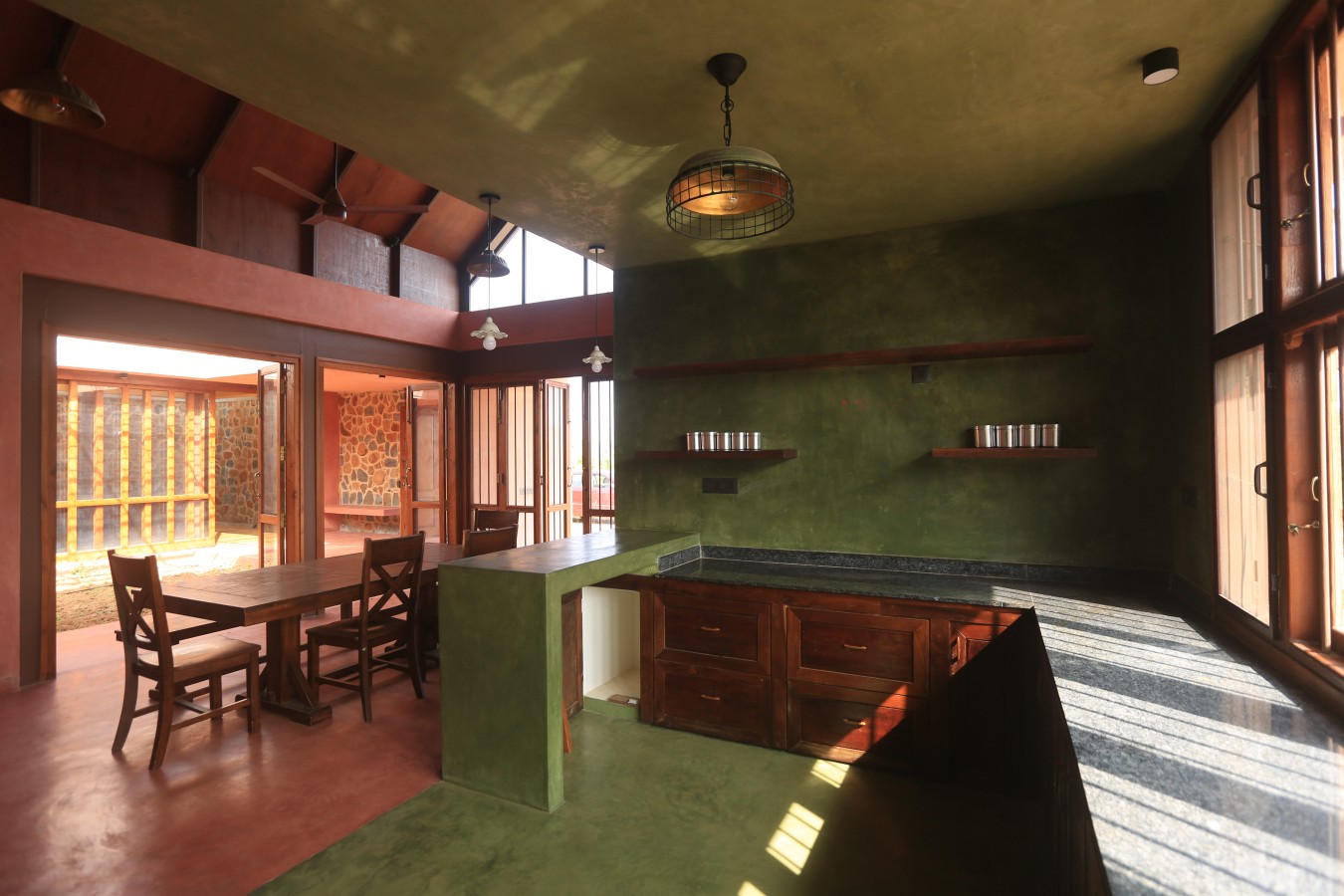 Kitchen and dining room with oxide flooring and lime plaster walls