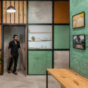 View of the partition wall composed of various plaster panels as seen from the Workspace