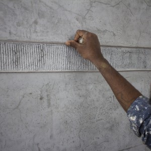 Mallappa, our artisan, fusses over the lime stains on the inlaid brass strip.