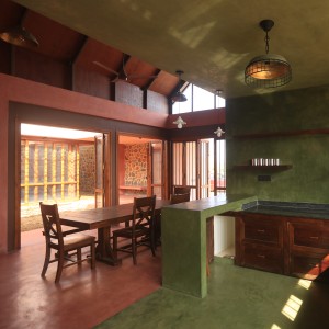 Kitchen and dining room with oxide flooring and lime plaster walls