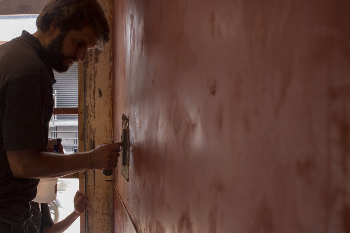 Jeremie Applies a cloat of clay plaster